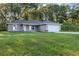 Charming single-story home with a well-manicured lawn and attached two car garage at 57 Pine Trace Crse, Ocala, FL 34472