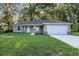 Charming single-story home with a well-manicured lawn and attached two car garage at 57 Pine Trace Crse, Ocala, FL 34472