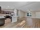 Open kitchen with stainless appliances, dark cabinets, and an island with granite counters at 57 Pine Trace Crse, Ocala, FL 34472