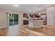 Open kitchen with stainless appliances, dark cabinets, and an island with granite counters at 57 Pine Trace Crse, Ocala, FL 34472
