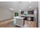 Bright kitchen featuring a kitchen island, stainless steel appliances, and backyard view at 57 Pine Trace Crse, Ocala, FL 34472