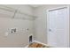 Laundry room with hookups, wire shelving, and a white door at 57 Pine Trace Crse, Ocala, FL 34472