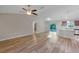 Open-concept living room and kitchen area with wood-style flooring and stainless appliances at 57 Pine Trace Crse, Ocala, FL 34472
