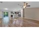 Open-concept living room and kitchen area with wood-style flooring and stainless appliances at 57 Pine Trace Crse, Ocala, FL 34472