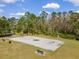 Outdoor basketball court surrounded by mature trees and green space at 6165 Carrier Dr # 2001, Orlando, FL 32819