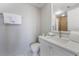 Well-lit bathroom with a modern vanity, clean toilet, and essential amenities provided at 6165 Carrier Dr # 2001, Orlando, FL 32819