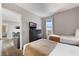 Bedroom with 2 beds, TV on a dresser, and sitting area with a view at 6165 Carrier Dr # 2001, Orlando, FL 32819