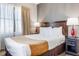Bright and inviting bedroom featuring a cozy queen bed and soft, natural light at 6165 Carrier Dr # 2001, Orlando, FL 32819