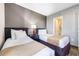 Comfortable bedroom with two beds and an adjoining bathroom at 6165 Carrier Dr # 2001, Orlando, FL 32819