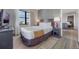 Comfortable bedroom featuring a large window with city views and stylish decor at 6165 Carrier Dr # 2001, Orlando, FL 32819