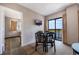 A dining area with seating for four, a TV, and a door leading to the balcony and a lake view at 6165 Carrier Dr # 2001, Orlando, FL 32819