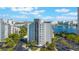 Stunning aerial view of the building showcasing lush landscaping, ample parking, and serene lake views at 6165 Carrier Dr # 2001, Orlando, FL 32819
