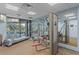 Modern gym with treadmill and weight machines overlooking a pool at 6165 Carrier Dr # 2001, Orlando, FL 32819