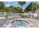 Relax in this inviting hot tub with brick surround and convenient grab rail at 6165 Carrier Dr # 2001, Orlando, FL 32819