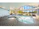 Enjoy the enclosed community indoor pool, complete with whirlpool, brick pavers, and large picture windows at 6165 Carrier Dr # 2001, Orlando, FL 32819