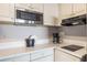 Close-up on the kitchen counter and appliances at 6165 Carrier Dr # 2001, Orlando, FL 32819