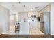 A bright kitchen with a peninsula, seating, stainless steel appliances, and white cabinetry at 6165 Carrier Dr # 2001, Orlando, FL 32819