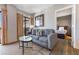 A spacious living area featuring a comfortable sofa, modern decor, and access to the bedroom at 6165 Carrier Dr # 2001, Orlando, FL 32819