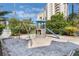 playground area with swings, slide, climbing structure, and sandy base at 6165 Carrier Dr # 2001, Orlando, FL 32819