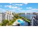 Aerial view showcasing the inviting community pool, spa, and scenic lake views surrounding the property at 6165 Carrier Dr # 2001, Orlando, FL 32819