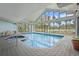Indoor pool and hot tub area with ample light and beautiful tile at 6165 Carrier Dr # 2001, Orlando, FL 32819