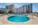 Great view of the outdoor community pool with lounge chairs and beautifully landscaped surroundings at 6165 Carrier Dr # 2001, Orlando, FL 32819