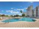 Enjoy the outdoors at the beautiful community pool, lounge chairs, and palm tree landscaping at 6165 Carrier Dr # 2001, Orlando, FL 32819