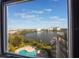 Picturesque view of lake and city skyline from room window, overlooking pool and lounge area at 6165 Carrier Dr # 2001, Orlando, FL 32819