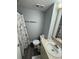 Cozy bathroom featuring a vanity with sink, decorative mirror, and a shower with themed curtains at 6165 Carrier Dr # 3104, Orlando, FL 32819
