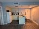 Cozy kitchen featuring white cabinetry and a breakfast bar at 6165 Carrier Dr # 3104, Orlando, FL 32819