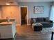 Inviting living room featuring a comfortable sofa, modern art, and an open doorway to the bedroom at 6165 Carrier Dr # 3104, Orlando, FL 32819