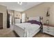 Bright bedroom with a white bed, carpeted floor and two white night stands at 625 Waterland Ct, Orlando, FL 32828