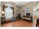 This bedroom features hardwood floors, a large arched window, a desk, and ample room for relaxing and working at 625 Waterland Ct, Orlando, FL 32828