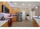 Well-lit kitchen boasts stainless steel appliances, wood cabinets, and a tile floor at 625 Waterland Ct, Orlando, FL 32828