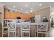 Bright, open kitchen with wooden cabinetry, stainless appliances, tile floors, and bar-top seating at 625 Waterland Ct, Orlando, FL 32828