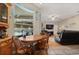 Cozy eat-in kitchen nook with wood table overlooks the living area and the screened-in pool at 625 Waterland Ct, Orlando, FL 32828