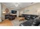 Comfortable living room area with a fireplace, leather sofas, and a nautical themed ship wheel decoration at 625 Waterland Ct, Orlando, FL 32828