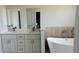 Bathroom features a soaking tub, double vanity with white cabinets at 6345 Sw 155Th Pl, Ocala, FL 34473