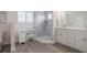 Bathroom featuring a glass shower, white vanity and hardwood floors at 743 Lake Douglas Dr, Groveland, FL 34736