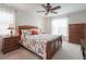 Comfortable bedroom featuring a floral comforter, ceiling fan, and ample natural light at 743 Lake Douglas Dr, Groveland, FL 34736