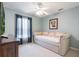Bedroom featuring a daybed, soft color palette, and a ceiling fan at 743 Lake Douglas Dr, Groveland, FL 34736