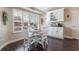 Cozy breakfast nook with white cabinets, plantation shutters, and a charming dining set at 743 Lake Douglas Dr, Groveland, FL 34736
