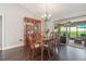 Elegant dining room with hardwood floors, a chandelier, and access to the patio at 743 Lake Douglas Dr, Groveland, FL 34736