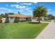 Attractive home with a lush green lawn, lovely landscaping, and an American flag at 743 Lake Douglas Dr, Groveland, FL 34736