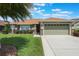 Charming home with a manicured lawn, beautiful landscaping, and a spacious two-car garage at 743 Lake Douglas Dr, Groveland, FL 34736