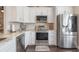 Bright kitchen with white cabinetry, stainless steel appliances, and granite countertops at 743 Lake Douglas Dr, Groveland, FL 34736