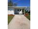 Inviting home exterior with a covered entryway and a freshly painted driveway at 769 Avenue Q Se, Winter Haven, FL 33880