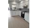 Well-equipped kitchen with white cabinets and new stainless steel range at 769 Avenue Q Se, Winter Haven, FL 33880