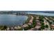 An aerial view of lakefront homes near a lake, with an illuminated city skyline in the background at dusk at 8161 Via Rosa, Orlando, FL 32836