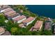 Aerial view of luxury homes with lush landscaping, private driveways, and stunning lake views at 8161 Via Rosa, Orlando, FL 32836
